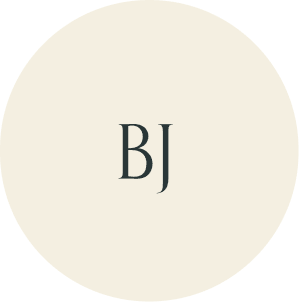 Cream circular monogram with BJ initials.