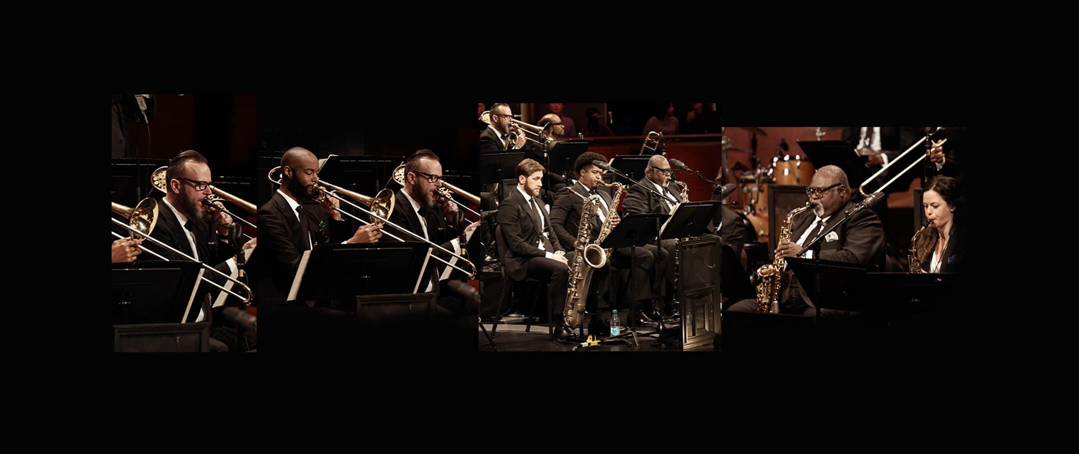 Jazz orchestra performing on stage in formal black suits.