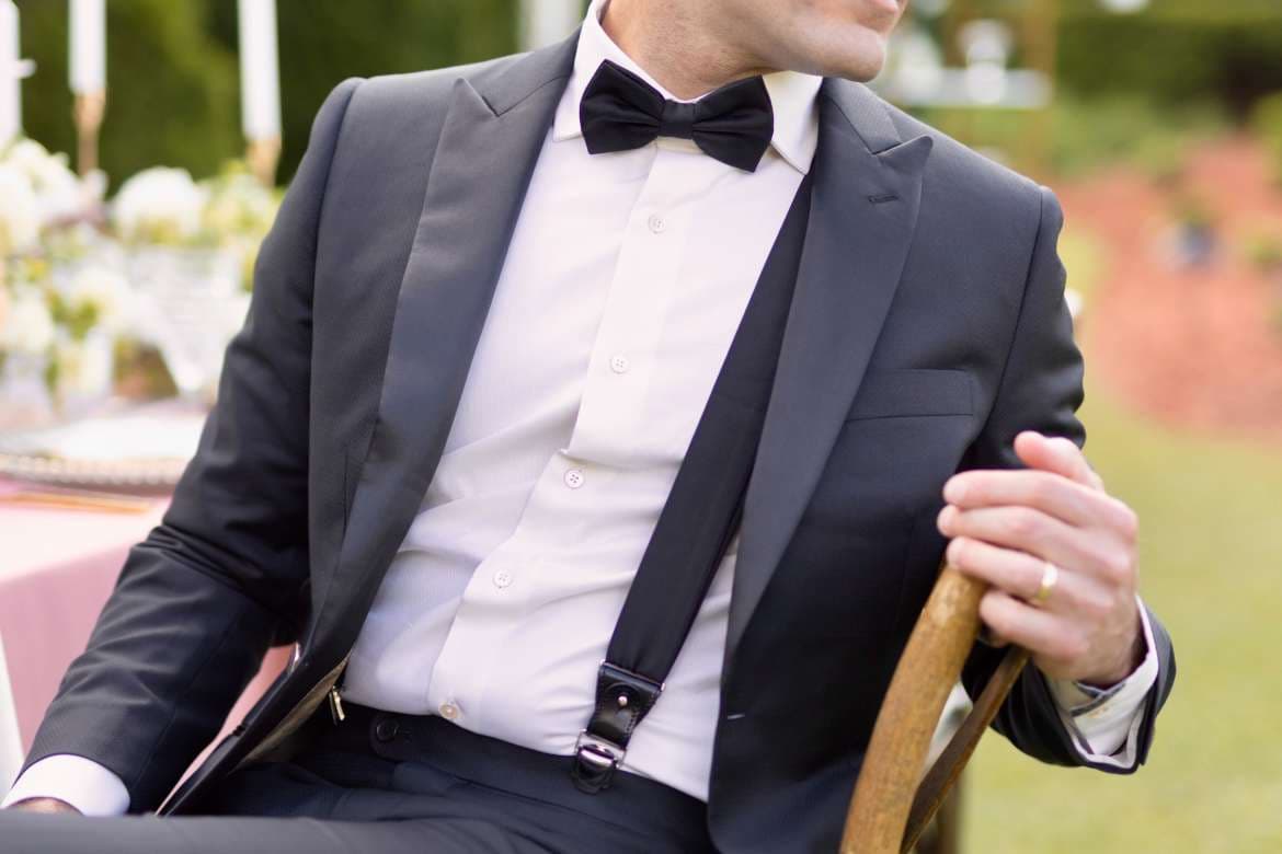 Groomsman wearing a suit for a wedding.