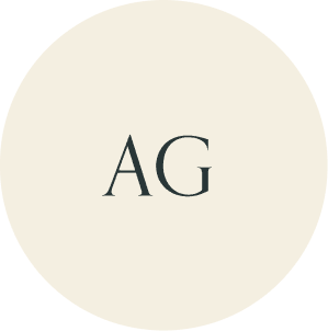 Cream circular monogram with AG initials.