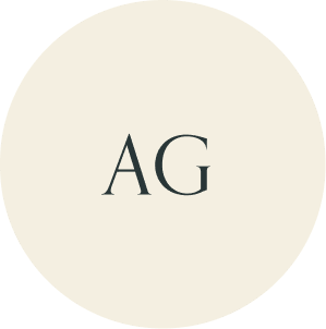 Cream circular monogram with AG initials.