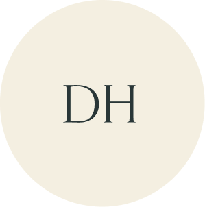 Cream circular monogram with DH initials.