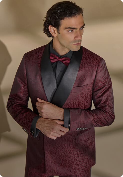 Man in a burgundy tuxedo jacket with black satin lapels.