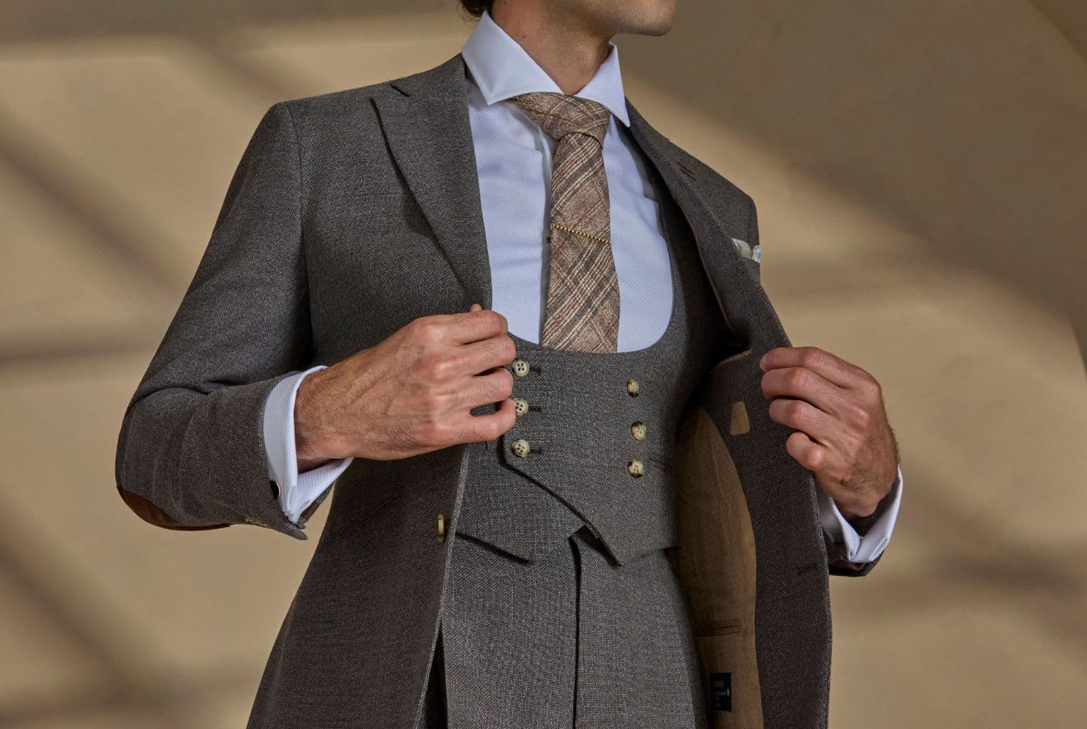 Close-up of tailored suit construction and lapel detail.