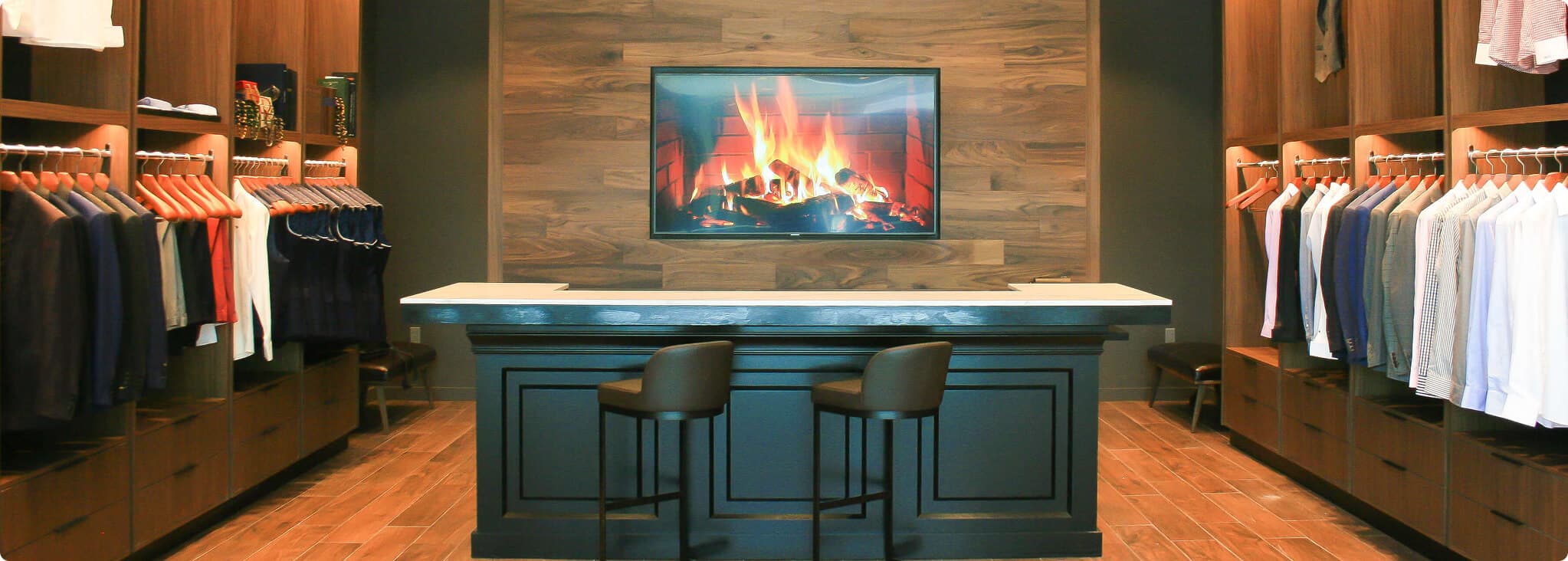 Hive & Colony showroom interior with clothing racks and a fireplace.