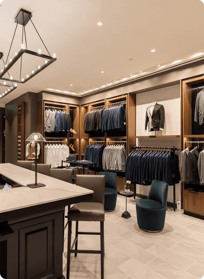 Dallas showroom with jacket displays, lounge chairs, and tailoring counter.