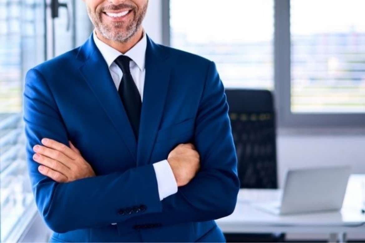 Man in a sharp tailored suit posing confidently.