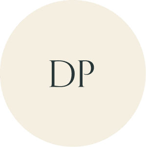 Cream circular monogram with DP initials.