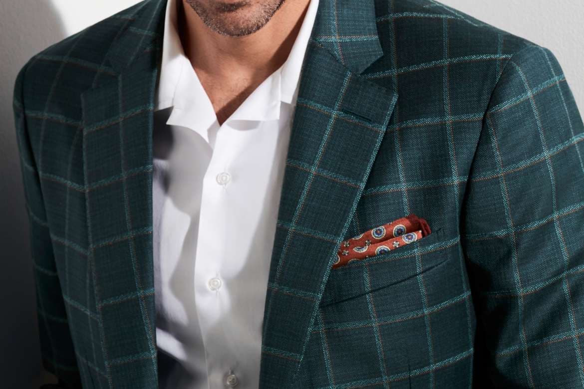 Close-up of a tailored suit with a folded pocket square.