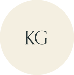 Cream circular monogram with KG initials.
