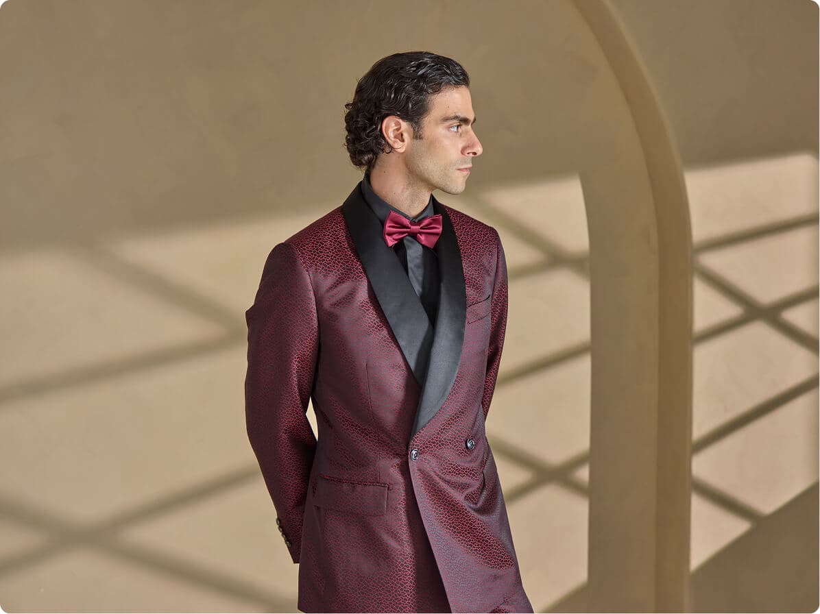 Man in a burgundy tuxedo jacket with black satin lapels.