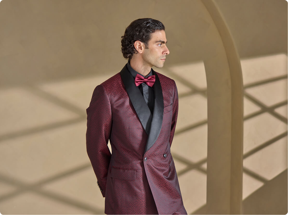 Man in a burgundy tuxedo jacket with black satin lapels.