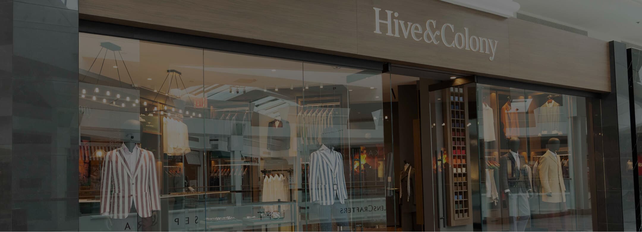 Hive & Colony storefront with striped jackets and menswear displays.