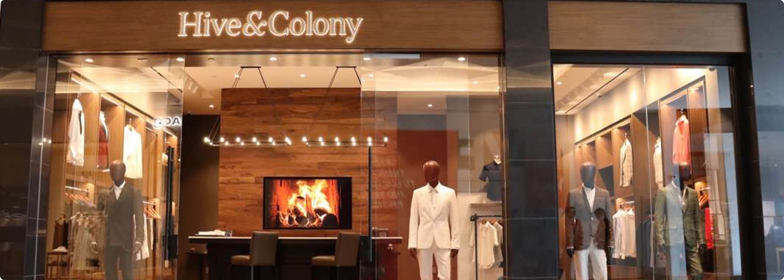 Hive & Colony storefront with mannequins in tailored suits.