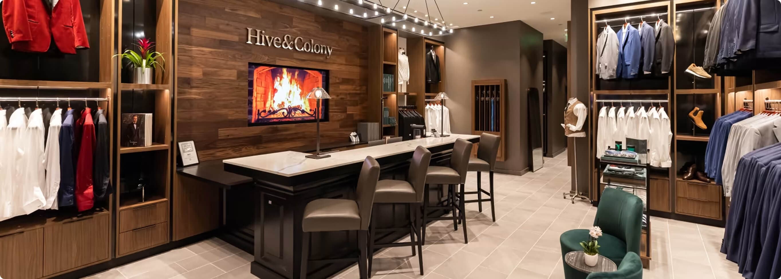 Hive & Colony showroom with suit displays, fitting counter, and seating.