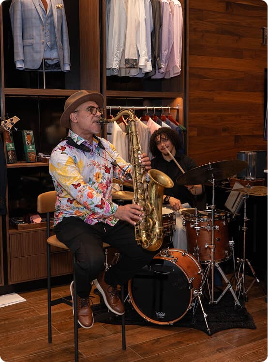 Saxophonist and drummer performing live inside the Hive & Colony showroom.