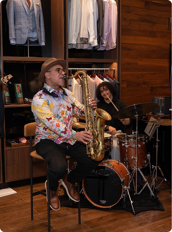 Saxophonist and drummer performing live inside the Hive & Colony showroom.