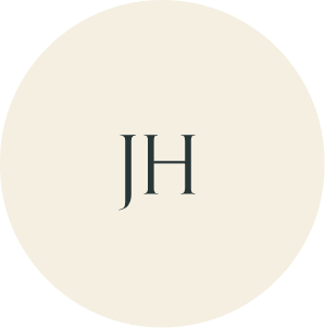 Cream circular monogram with JH initials.