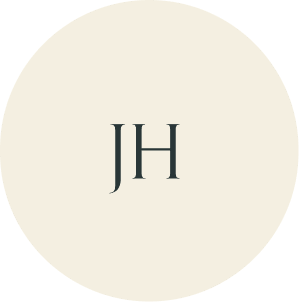 Cream circular monogram with JH initials.