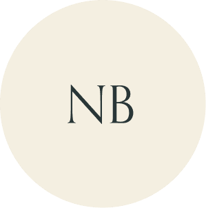 Cream circular monogram with NB initials.
