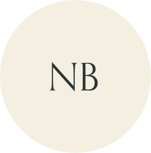 Cream circular monogram with NB initials.