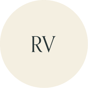 Cream circular monogram with RV initials.