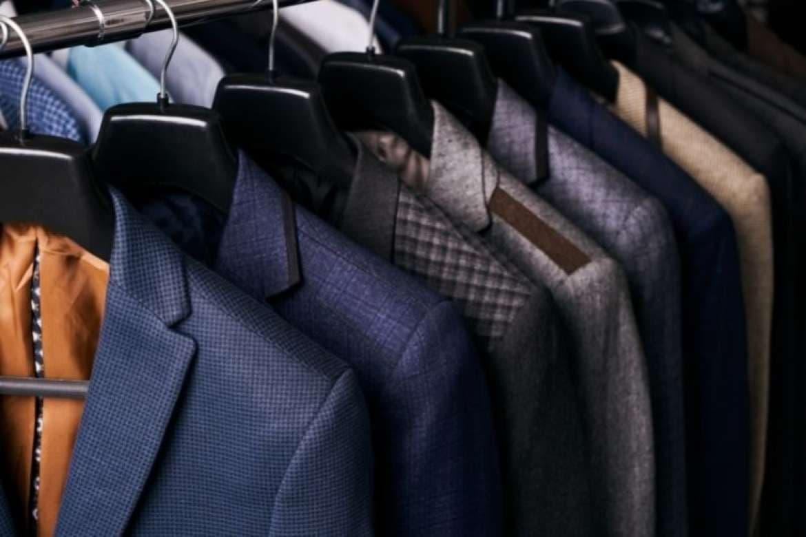 Suit fabrics in varied colors for custom tailoring.
