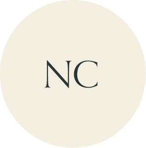 Cream circular monogram with NC initials.