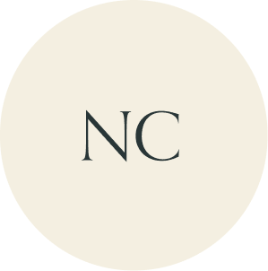 Cream circular monogram with NC initials.