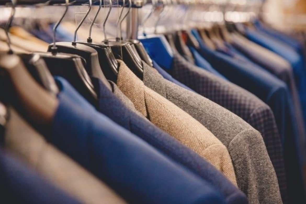 Rack of tailored jackets in blue, gray, and neutral tones.