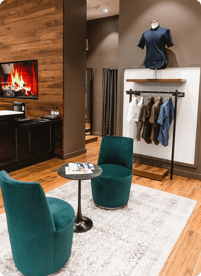 Santa Clara showroom lounge with green chairs and a shirt display.