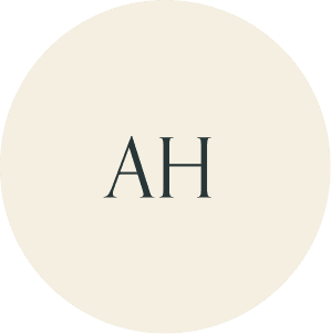 Cream circular monogram with AH initials.