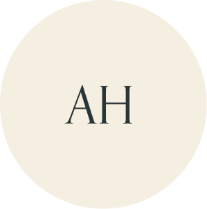 Cream circular monogram with AH initials.