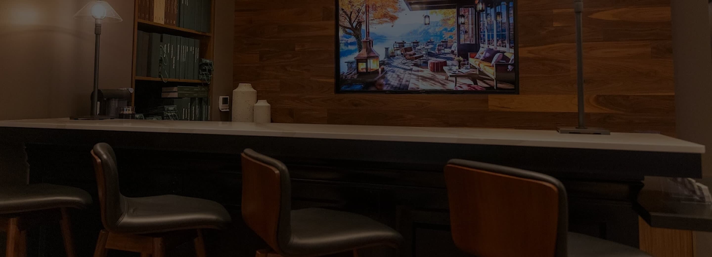 Hive & Colony fitting counter with leather chairs and wall display.