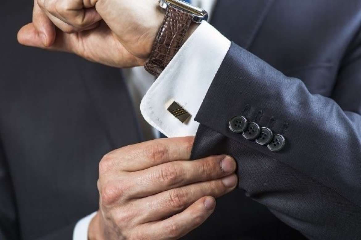 Menswear accessories arranged with a bespoke suit.