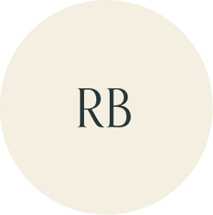 Cream circular monogram with RB initials.