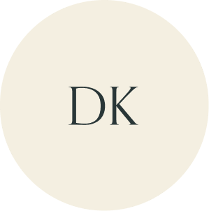 Cream circular monogram with DK initials.