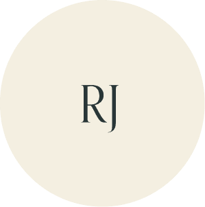 Cream circular monogram with RJ initials.