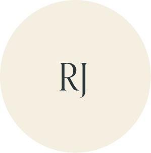 Cream circular monogram with RJ initials.