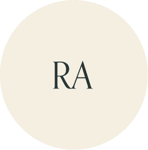 Cream circular monogram with RA initials.
