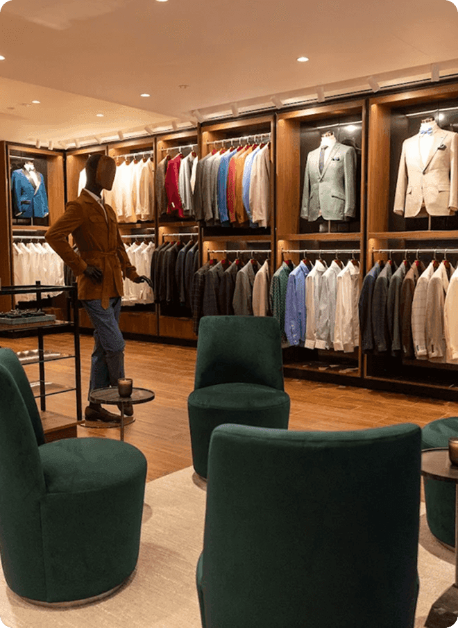 Madison showroom lounge with green chairs, mannequins, and clothing displays.