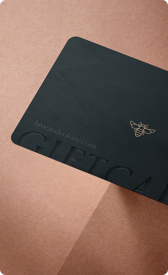 Black Hive & Colony gift card on a warm textured surface.