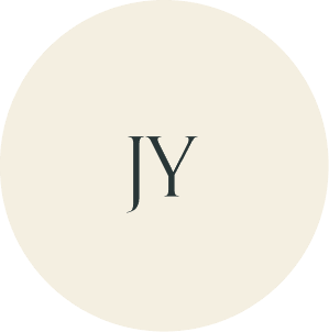 Cream circular monogram with JY initials.
