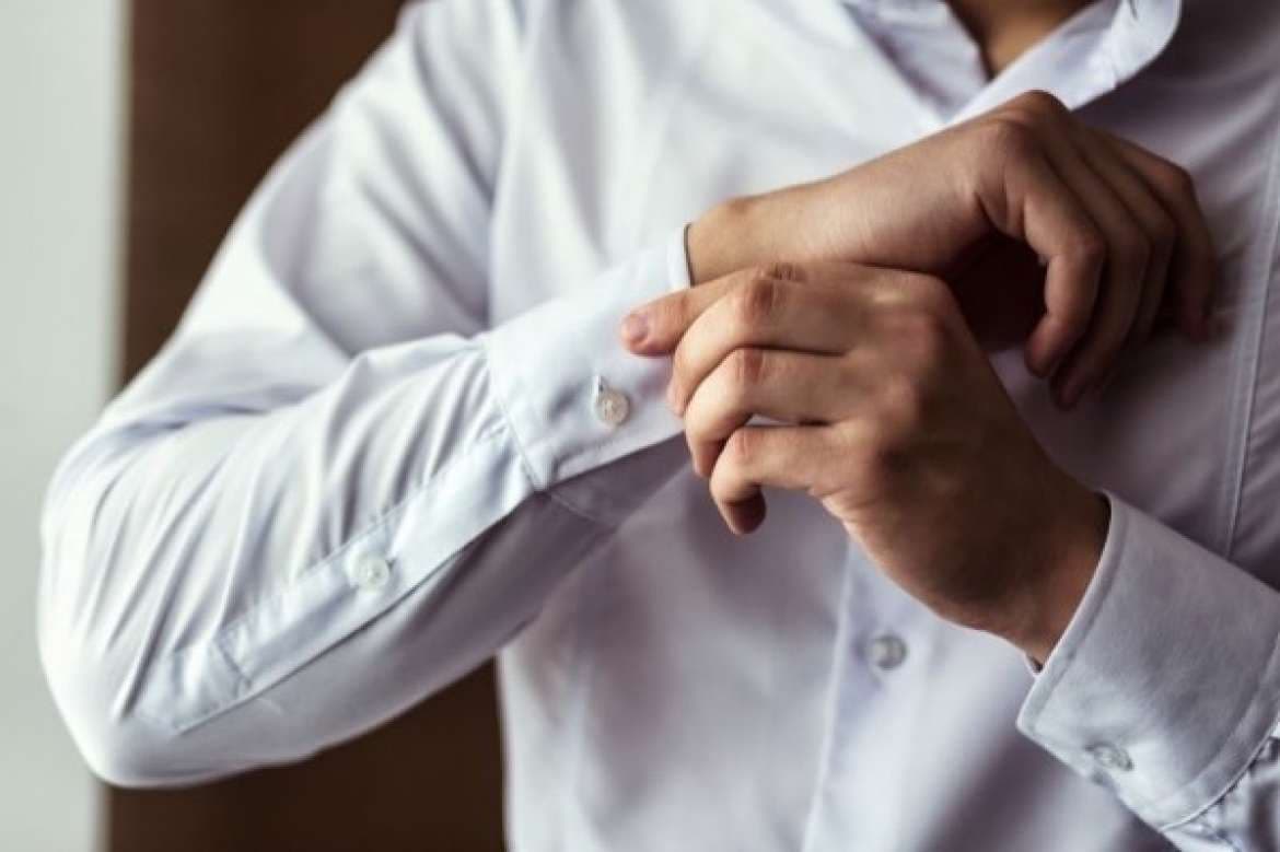 Custom dress shirts displayed with tailoring details.