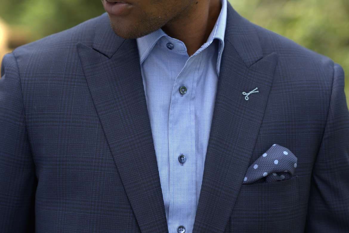 Man wearing a checked suit jacket with refined styling.