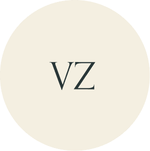 Cream circular monogram with VZ initials.
