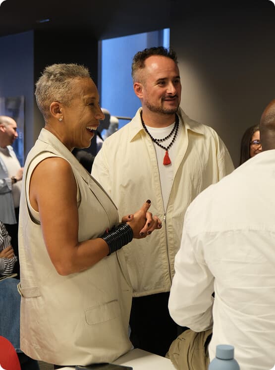 Two guests talking during the A Cut Above final showcase.