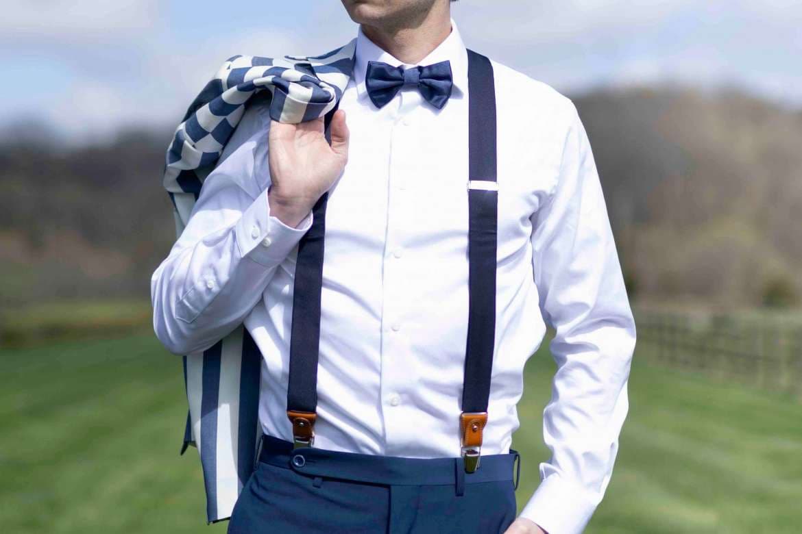 Man wearing suspenders with a tailored dress shirt.