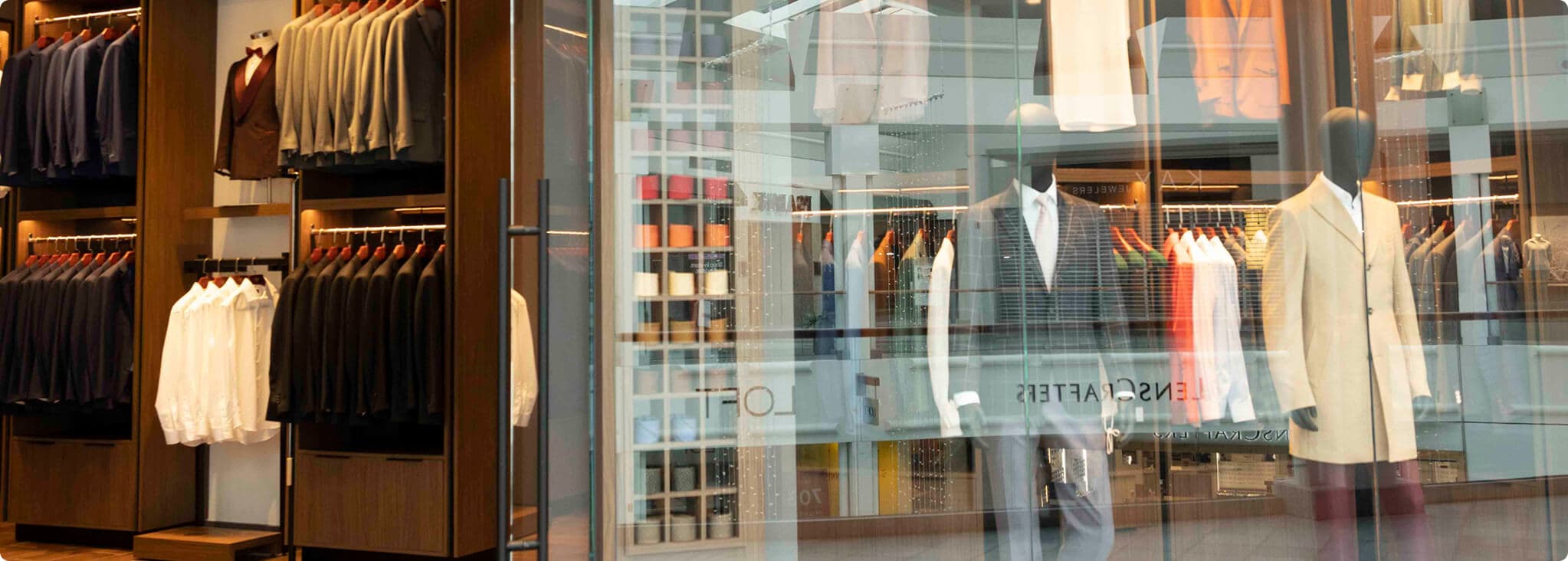 Hive & Colony storefront with mannequins and suit racks.