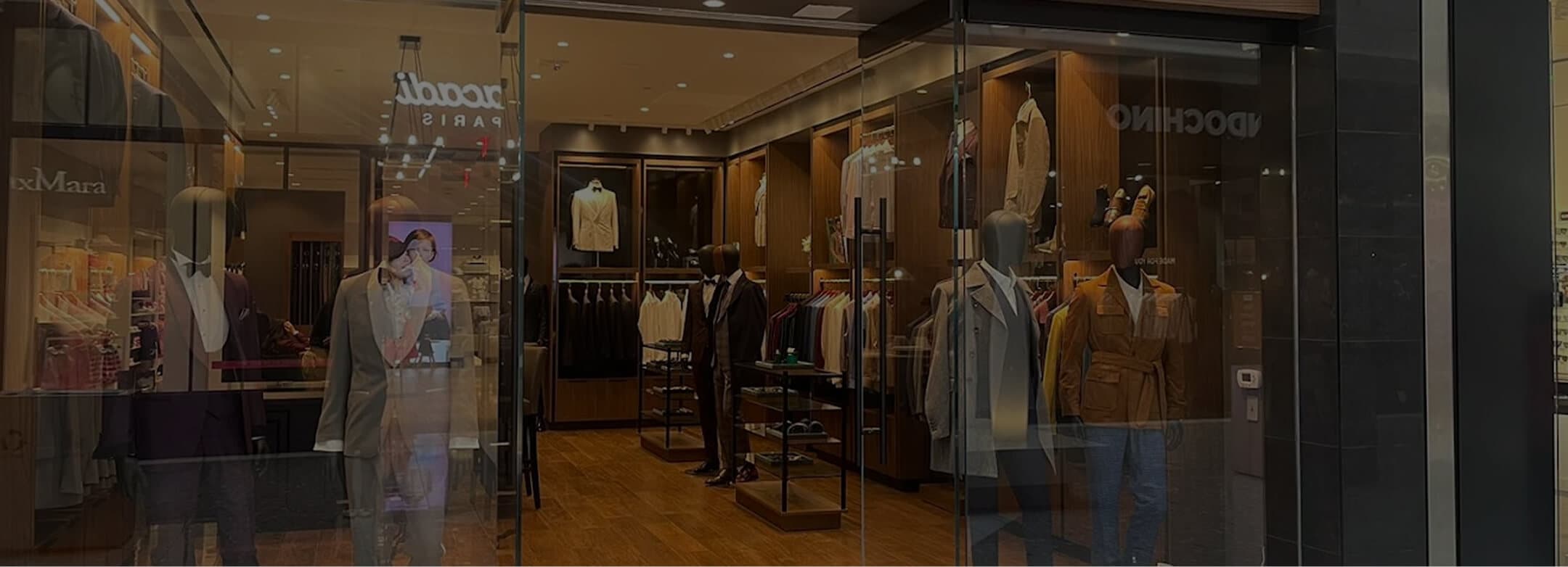 Hive & Colony storefront with mannequins and tailored menswear displays.